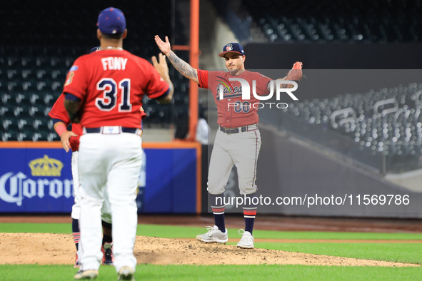 Josh Burgos #00 of New York's Bravest celebrates the final out during the baseball game against the NYPD baseball team in the 'Battle of Bad...