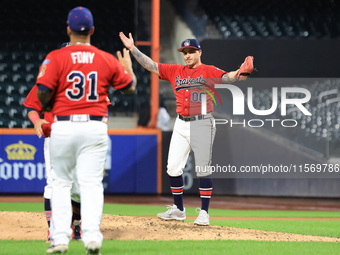 Josh Burgos #00 of New York's Bravest celebrates the final out during the baseball game against the NYPD baseball team in the 'Battle of Bad...