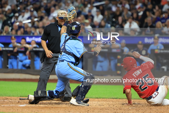 New York's Finest catcher Domenick Camerada #4 tags out New York's Bravest Kevin Diaz #25 during the baseball game against the FDNY baseball...