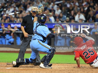 New York's Finest catcher Domenick Camerada #4 tags out New York's Bravest Kevin Diaz #25 during the baseball game against the FDNY baseball...