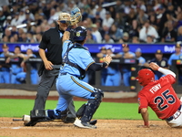 New York's Finest catcher Domenick Camerada #4 tags out New York's Bravest Kevin Diaz #25 during the baseball game against the FDNY baseball...