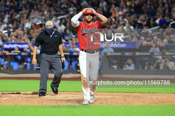 Kevin Diaz #25 of New York's Bravest reacts after being called out at home plate during the baseball game against the NYPD baseball team in...