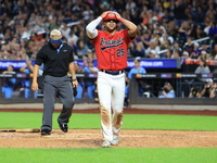 Kevin Diaz #25 of New York's Bravest reacts after being called out at home plate during the baseball game against the NYPD baseball team in...