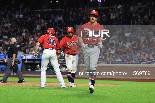 Matt Diorio #14 of New York's Bravest scores during the baseball game against the NYPD baseball team in the 'Battle of Badges' at Citi Field...