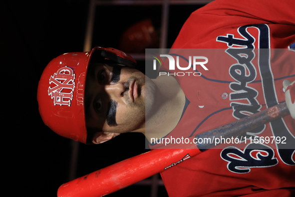 John Giakas #9 stands in the dugout waiting to bat during the baseball game against the NYPD baseball team in the 'Battle of Badges' at Citi...