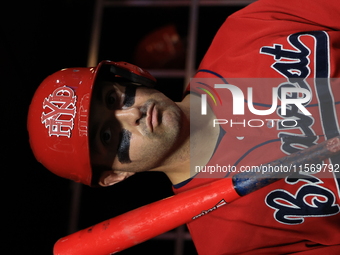 John Giakas #9 stands in the dugout waiting to bat during the baseball game against the NYPD baseball team in the 'Battle of Badges' at Citi...