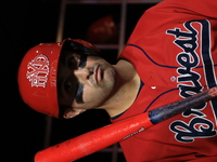 John Giakas #9 stands in the dugout waiting to bat during the baseball game against the NYPD baseball team in the 'Battle of Badges' at Citi...