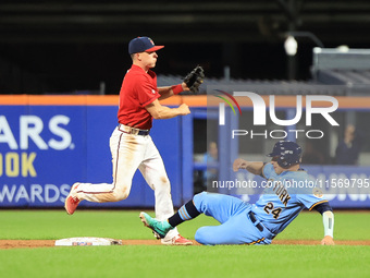 Brian Luebcke #4 fields and throws to first base as PJ Ragone #24 slides into second base during the baseball game against the NYPD baseball...