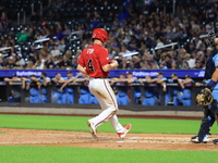 New York's Bravest Brian Luebcke #4 is congratulated after scoring during the baseball game against the NYPD baseball team in the 'Battle of...