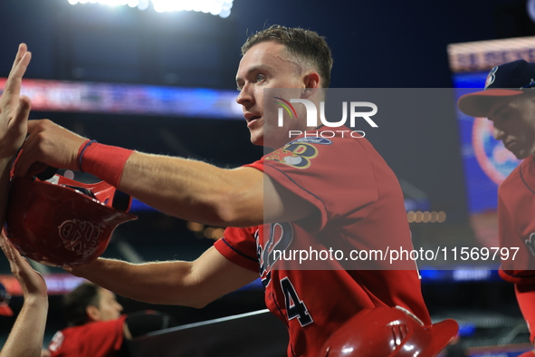 New York's Bravest Brian Luebcke #4 is congratulated after scoring during the baseball game against the NYPD baseball team in the 'Battle of...