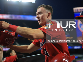 New York's Bravest Brian Luebcke #4 is congratulated after scoring during the baseball game against the NYPD baseball team in the 'Battle of...