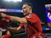 New York's Bravest Brian Luebcke #4 is congratulated after scoring during the baseball game against the NYPD baseball team in the 'Battle of...