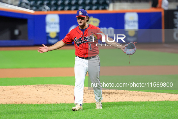 Tim Panetta #1, a pitcher for New York's Bravest, reacts as he comes off the field during the seventh inning of the baseball game against th...