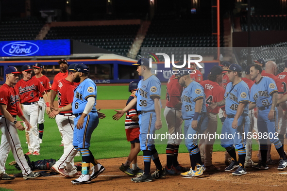 New York's Bravest exchanges handshakes with New York's Finest after the 'Battle of Badges' at Citi Field in Corona, New York, on September...