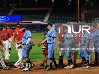 New York's Bravest exchanges handshakes with New York's Finest after the 'Battle of Badges' at Citi Field in Corona, New York, on September...