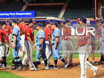 New York's Bravest exchanges handshakes with New York's Finest after the 'Battle of Badges' at Citi Field in Corona, New York, on September...