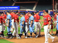 New York's Bravest exchanges handshakes with New York's Finest after the 'Battle of Badges' at Citi Field in Corona, New York, on September...