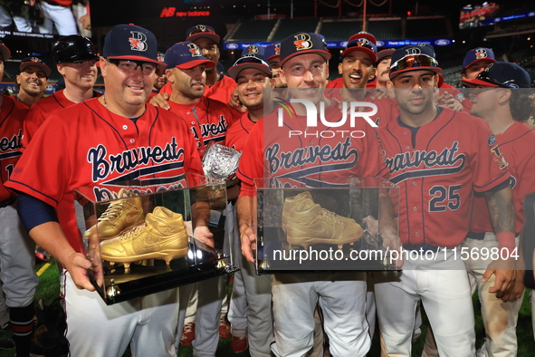 Tom Reznick #22 and Dan Quinn #34 hold retired golden spikes after playing their final game after the 'Battle of Badges' at Citi Field in Co...