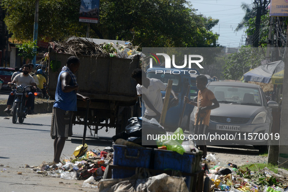 Workers and laborers collect roadside household waste thrown at the roadside in Siliguri, India, on September 13, 2024. 