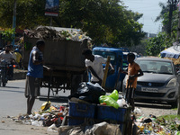 Workers and laborers collect roadside household waste thrown at the roadside in Siliguri, India, on September 13, 2024. (