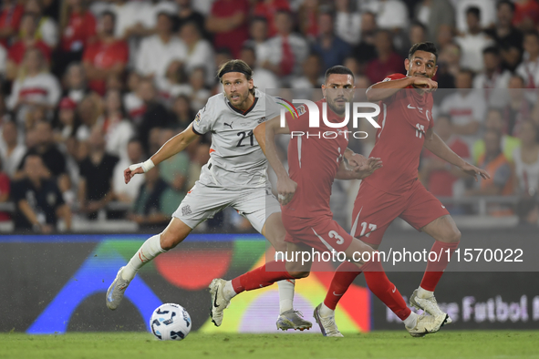 Arnor Ingvi Traustason  and Merih Demiral  during the UEFA Nations League 2024/25 League B Group B4 match between Turkiye and Iceland at Gür...