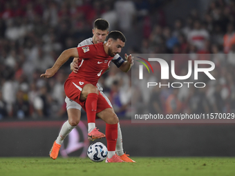 Orkun Kokcu of Turkey and Johann Gudmundsson of Iceland   during the UEFA Nations League 2024/25 League B Group B4 match between Turkiye and...