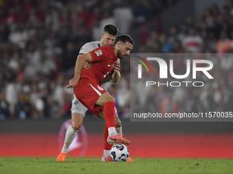 Johann Gudmundsson of Iceland and Orkun Kokcu of Turkey   during the UEFA Nations League 2024/25 League B Group B4 match between Turkiye and...