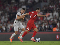 Johann Gudmundsson of Iceland and Orkun Kokcu of Turkey   during the UEFA Nations League 2024/25 League B Group B4 match between Turkiye and...