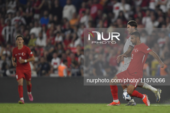 Zeki Celik of Turkey and Johann Gudmundsson of Iceland   during the UEFA Nations League 2024/25 League B Group B4 match between Turkiye and...