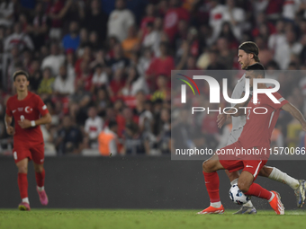 Zeki Celik of Turkey and Johann Gudmundsson of Iceland   during the UEFA Nations League 2024/25 League B Group B4 match between Turkiye and...