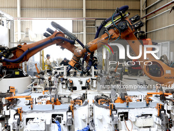 Robots rush to make sheet metal products for car bodies at a production workshop of an intelligent manufacturing enterprise in Fuzhou, Fujia...