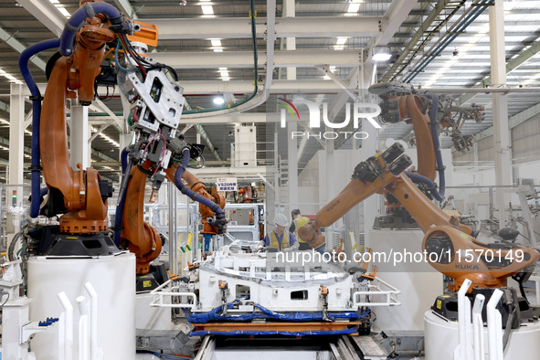 Robots rush to make sheet metal products for car bodies at a production workshop of an intelligent manufacturing enterprise in Fuzhou, Fujia...