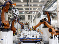 Robots rush to make sheet metal products for car bodies at a production workshop of an intelligent manufacturing enterprise in Fuzhou, Fujia...