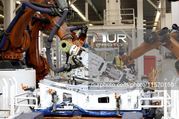 Robots rush to make sheet metal products for car bodies at a production workshop of an intelligent manufacturing enterprise in Fuzhou, Fujia...