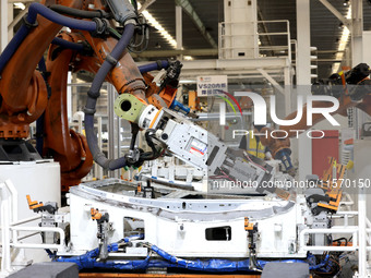 Robots rush to make sheet metal products for car bodies at a production workshop of an intelligent manufacturing enterprise in Fuzhou, Fujia...