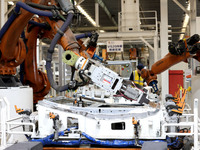 Robots rush to make sheet metal products for car bodies at a production workshop of an intelligent manufacturing enterprise in Fuzhou, Fujia...