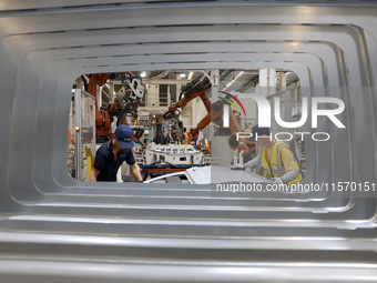 A worker rushes to make auto body sheet metal parts at a production workshop of an intelligent manufacturing enterprise in Fuzhou, China, on...