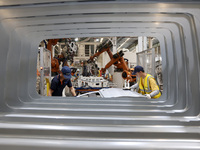 A worker rushes to make auto body sheet metal parts at a production workshop of an intelligent manufacturing enterprise in Fuzhou, China, on...