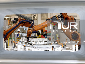 Robots rush to make sheet metal products for car bodies at a production workshop of an intelligent manufacturing enterprise in Fuzhou, Fujia...