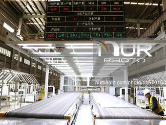 A worker rushes to make auto body sheet metal parts at a production workshop of an intelligent manufacturing enterprise in Fuzhou, China, on...