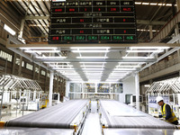 A worker rushes to make auto body sheet metal parts at a production workshop of an intelligent manufacturing enterprise in Fuzhou, China, on...