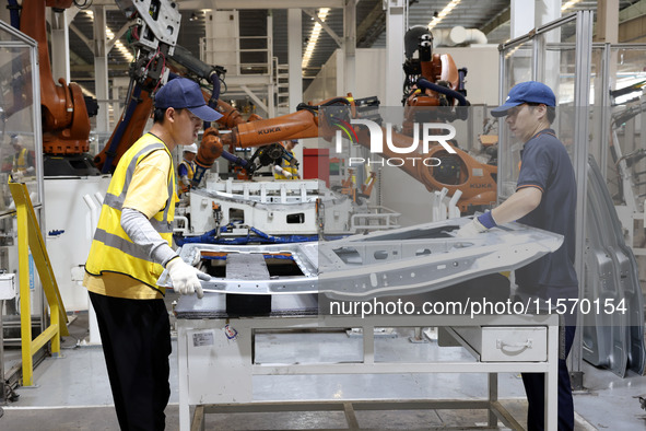 A worker rushes to make auto body sheet metal parts at a production workshop of an intelligent manufacturing enterprise in Fuzhou, China, on...