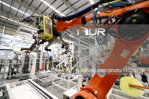 A technician debuts an intelligent robot arm at a production workshop of an intelligent manufacturing enterprise in Fuzhou, China, on Septem...