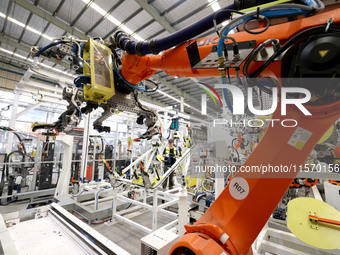 A technician debuts an intelligent robot arm at a production workshop of an intelligent manufacturing enterprise in Fuzhou, China, on Septem...