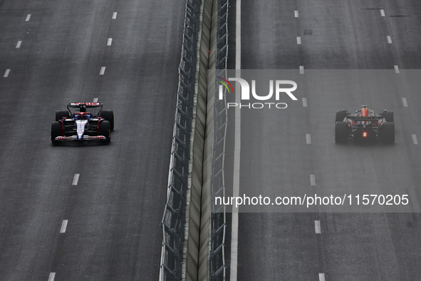 Daniel Ricciardo of RB and Sergio Perez of Red Bull Racing during first practice ahead of the Formula 1 Grand Prix of Azerbaijan at Baku Cit...