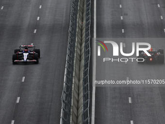 Daniel Ricciardo of RB and Sergio Perez of Red Bull Racing during first practice ahead of the Formula 1 Grand Prix of Azerbaijan at Baku Cit...