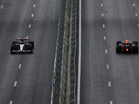 Daniel Ricciardo of RB and Sergio Perez of Red Bull Racing during first practice ahead of the Formula 1 Grand Prix of Azerbaijan at Baku Cit...