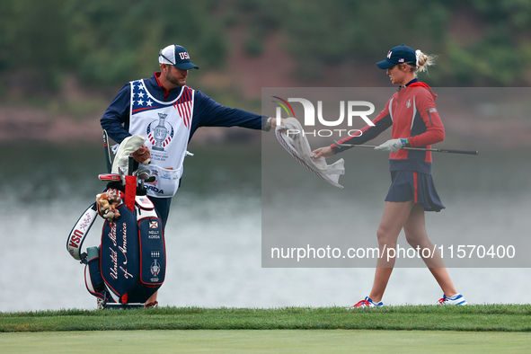 GAINESVILLE, VIRGINIA - SEPTEMBER 13: Nelly Korda of the United States takes a towel from her caddie during Day One of the Solheim Cup at Ro...