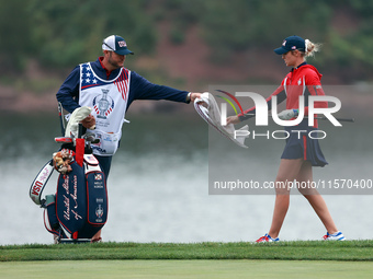 GAINESVILLE, VIRGINIA - SEPTEMBER 13: Nelly Korda of the United States takes a towel from her caddie during Day One of the Solheim Cup at Ro...