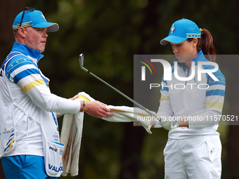 GAINESVILLE, VIRGINIA - SEPTEMBER 13: Albane Valenzuela of Team Europe takes a towel from her caddie at the 9th tee during Day One of the So...